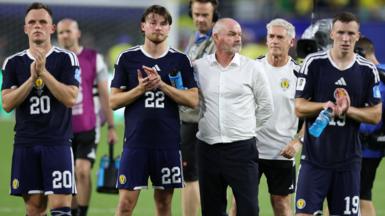 Steve Clarke and Scotland players applaud and look dejected after their World Cup defeat by Brazil