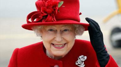 Queen Elizabeth II in a red dress and hat in 2011