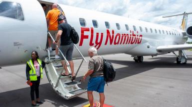 Tourists board a FlyNamibia aircraft