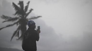 A man uses his cellphone at the waterfront in Kingston on October 27, 2025