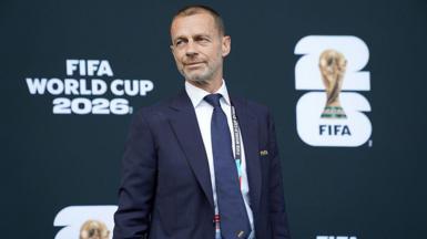 Uefa president Aleksander Ceferin in front of signage which reads Fifa World Cup 2026