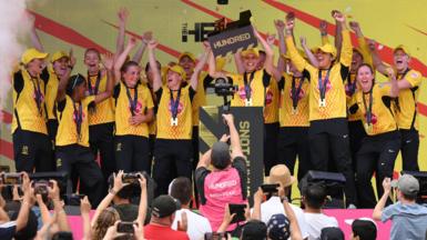 Trent Rockets players lift The Hundred trophy in celebration
