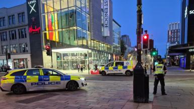 Police vehicles and officers outside the St Enoch Centre in Glasgow at night