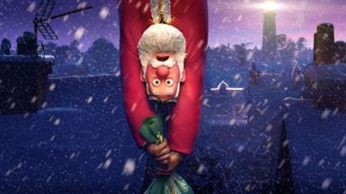 Santa Claus hanging upside down, clinging on to his sackful of presents as they dangle beneath him, in a promotional still for Netflix's That Christmas