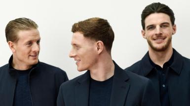 Jordan Pickford, Elliot Anderson, Declan Rice pose in navy smart-casual clothing from the M and S England collection