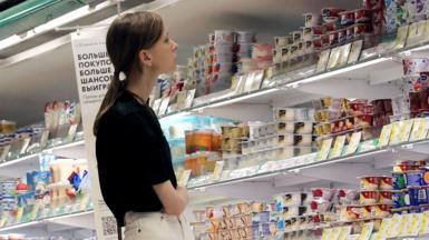 A customer shops for dairy products at a supermarket in Saint Petersburg, Russia