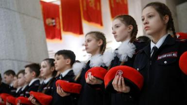 Russian teenagers with red berets take part in a ceremony of joining a patriotic cadet movement of the Youth Army
