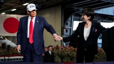U.S. President Donald Trump leads Japanese Prime Minister Sanae Takaichi off the stage after speaking to troops aboard USS George Washington at Fleet Activities Yokosuka on October 28, 2025 in Yokosuka, Japan. Trump is visiting Japan, fresh off an appearance at the ASEAN summit in Malaysia, and will next travel to South Korea for the APEC meetings. 