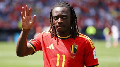 Jeremy Doku waves to the crowd while playing for Belgium