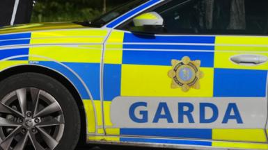 A yellow and blue garda vehicle with silver alloys and wing mirrors.