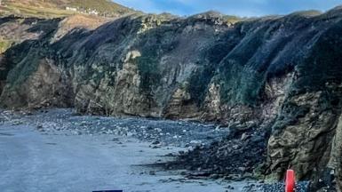 A cliff top seen from the beach