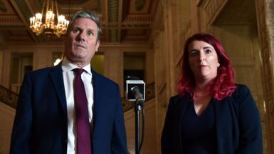 Sir Keir Starmer in a suit and tie standing next to Louise Haigh, who has red hair and is wearing a dark suit