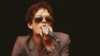 Jarvis Cocker plays at the Glastonbury Festival in 1995