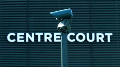A line camera is pictured with Centre Court in the background