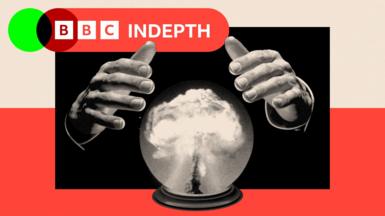 A black and white image showing a pair of hands hovering above a crystal ball with bomb smoke rising in the middle