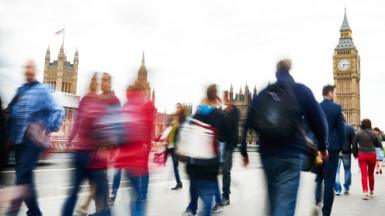 People walking past the Houses of Parliament