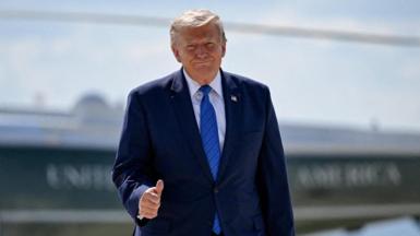 U.S. President Donald Trump gives thumbs-up as he walks from Marine One to board Air Force One.