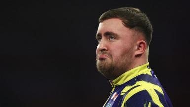 Luke Littler looks on