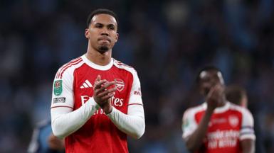 Gabriel Magalhaes, in Arsenal's red and white shirt, claps fans after playing in the Carabao Cup final