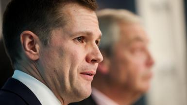 Robert Jenrick at a Reform UK press conference, with Nigel Farage in the background