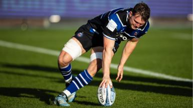 Bath's Ted Hill taps the ball down to score a try during their win against Sale