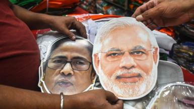 Cutout masks of Narendra Modi and Mamata Banerjee