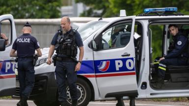 French policemen stand guard at the toll station of Incarville, near Rouen, in the North of France, where gunmen ambushed a prison van on 14 May 2024, killing two prison guards and helping a prisoner to escape.