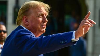 Donald Trump points his finger up