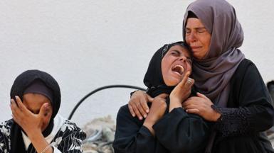 Women cry as they mourn the death of a loved one killed during overnight Israeli bombardment on June 12, 2025, at Al-Shifa hospital in Gaza City, amid the ongoing war between Israel and the Palestinian Hamas militant group.