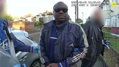 Still of Met Police detaining Simon Levy on a street