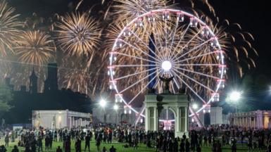 People watch a fireworks display that is attempting the largest firework display in history with 850,000 fireworks 