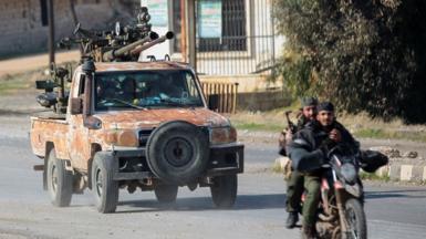 A car with weapons and two men on a motorbike ride 