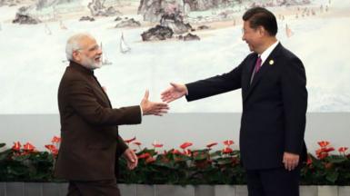 Indian Prime Minister Narendra Modi (L) shakes hands with Chinese President Xi Jinping (R) prior to the dinner on September 4, 2017