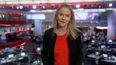 BBC Diplomatic correspondent Caroline Hawley wearing red t-shirt and black cardigan