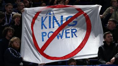 A sign is held by some Leicester City fans in protest of the club's ownership