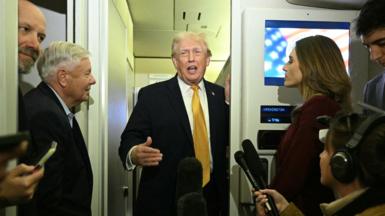 US President Trump aboard Air Force One on 4 January.