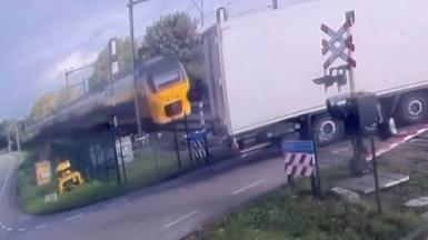 Train approaches truck at level crossing