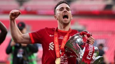 Diogo Jota celebrates with the FA Cup trophy following Liverpool's win over Chelsea in 2022