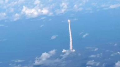 The view from a commercial flight of the Artemis II mission spacecraft in the sky during blast off.