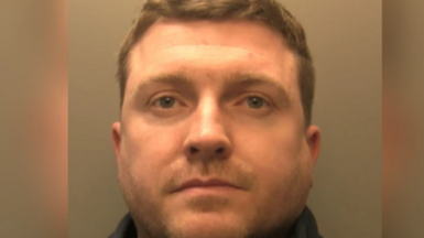 Close up custody image of Robert. He has short light brown hair. Robert is wearing a black fleece.