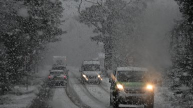 Vehicles navigate snowy conditions near Glenmore on the road to the Cairngorm ski area