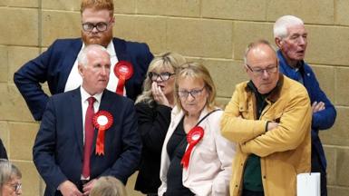 Labour party activists look on as ballot papers are counted for the 2026 Essex County Council election at Clacton Leisure Centre in Essex