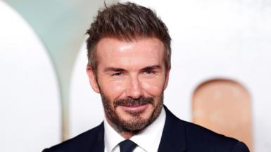 David Beckham wears a black suit and tie at the premiere of the "99" documentary about Manchester United. 