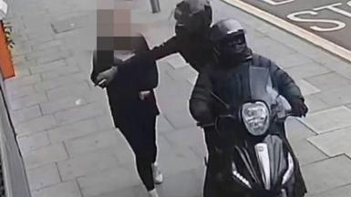 Handout photo issued by Metropolitan Police of a phone snatching incident in London.