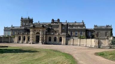 Shrubland Hall is a large historic building which has a large driveway in front of it. The building has a main entrance in the middle.
