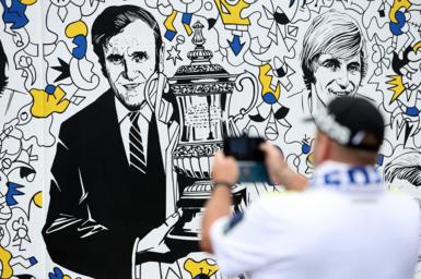 A fan takes a photo of a Don Revie picture