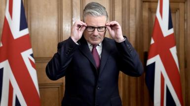 Prime Minister Sir Keir Starmer adjusts his glasses as he speaks in Downing Street, Westminster, London, in April 2026
