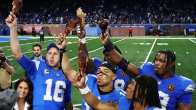 The Detroit Lions celebrate and eat turkey after beating the Chicago Bears