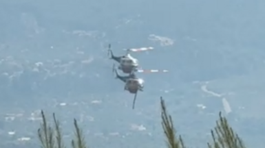 A screenshot showing two helicopters in Greece battling wildfires just moments before the mid-air collision. Photo: 2 August 2026