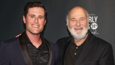 Jake Reiner, left, and his father Rob Reiner smiling while posing together at a vent in Hollywood in 2024.